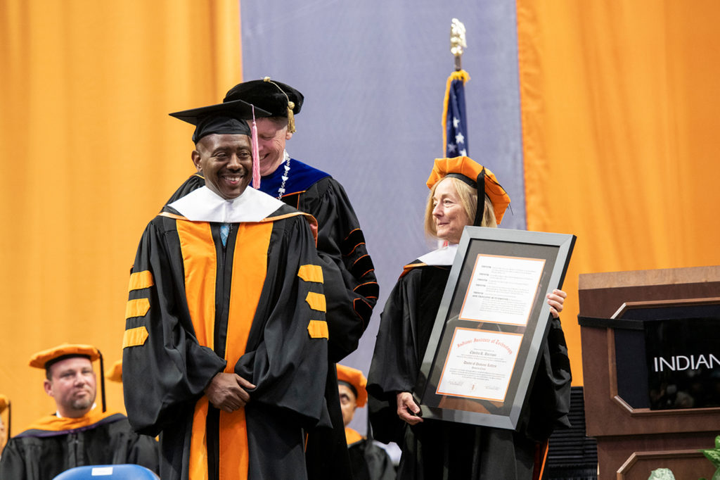 2018 Commencement keynote speaker Rev. Charles Harrison receiving his honorary degree