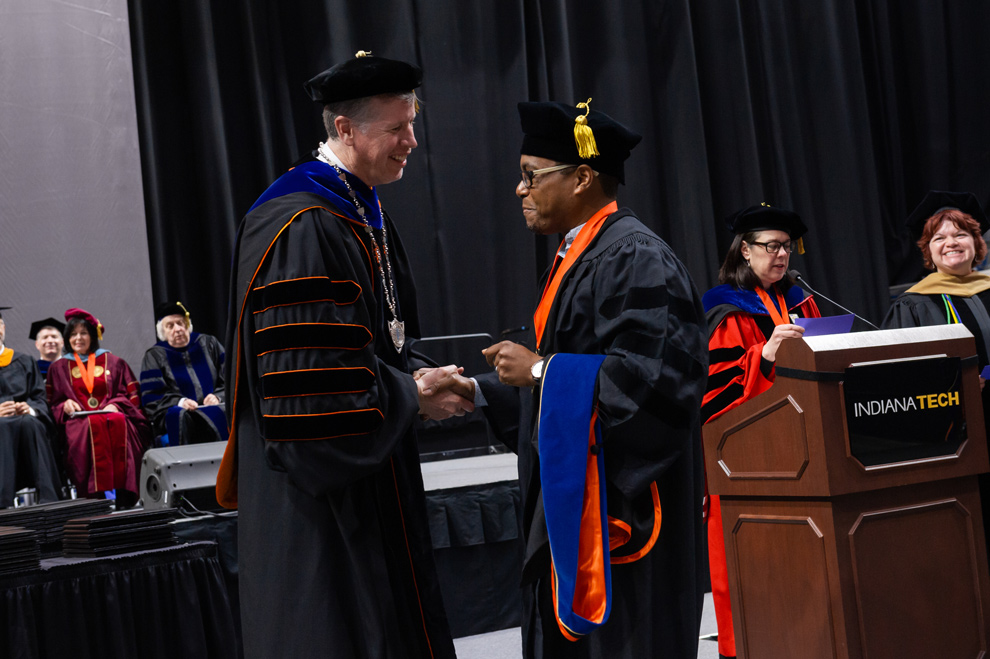 Ph.D. Graduate shaking hands with President Einolf during the 2019 commencement