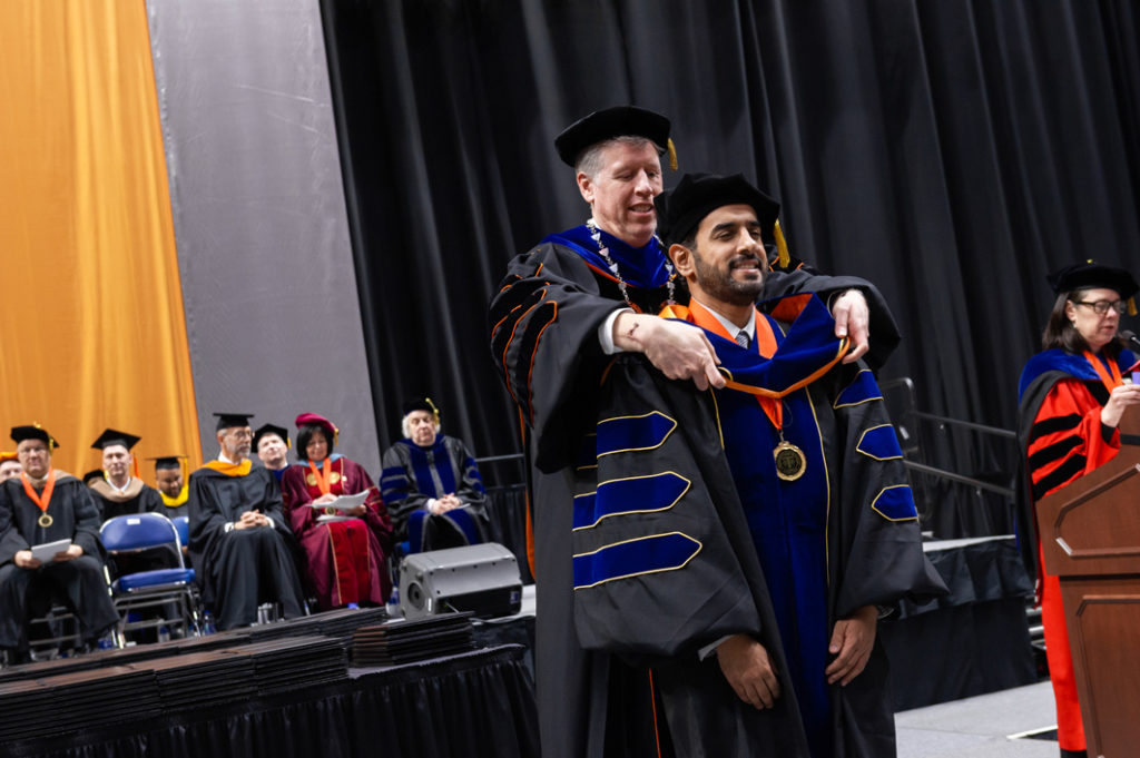 Ph.D. Graduate receiving his hood during the 2019 commencement ceremony