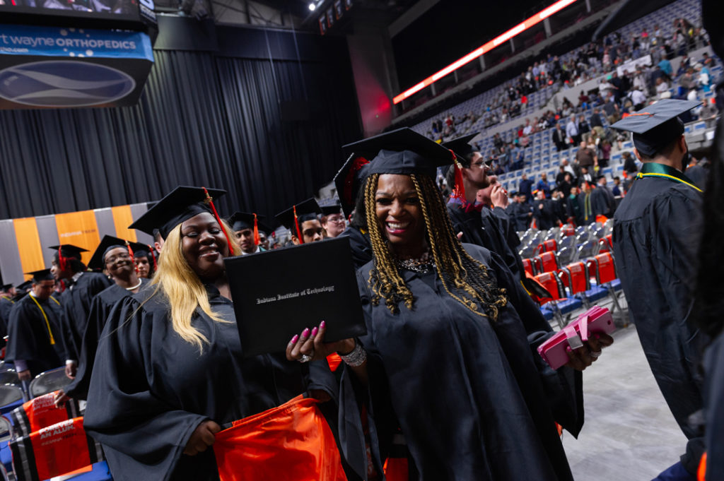 Graduate celebrating with her degree at the 2019 commencement ceremony