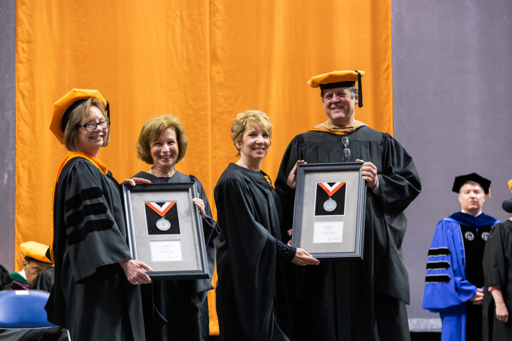 Rachel Tobin-Smith and Pattie Hays receiving the Indiana Tech President’s Medal in honor of their service to the community