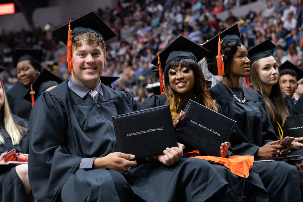 Indiana Tech graduates displaying their Indiana Tech Institution of Technology degrees