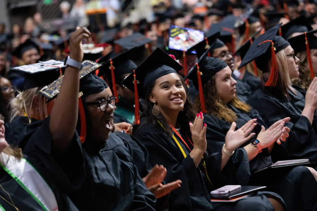 Graduates celebrating from their seats during the commencement ceremony of 2019