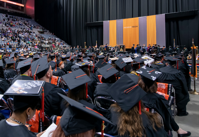 Graduating class of 2019 seated as their classmates walk to receive their degrees