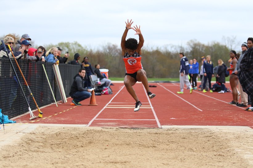 Destiny Copeland jumping during a women's outdoor track and field tournament