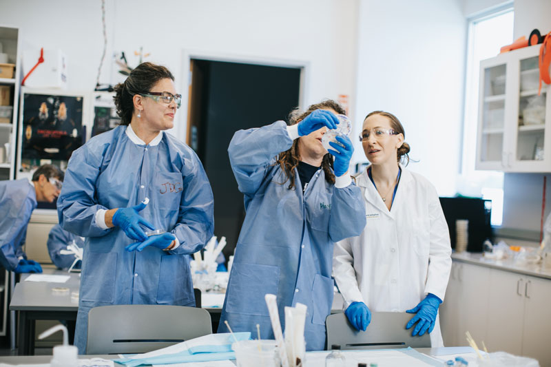 Associate Professor of Biology Julie Good, left, participates in Small World Initiative partner training earlier this summer. Kathy Tran for Small World Initiative