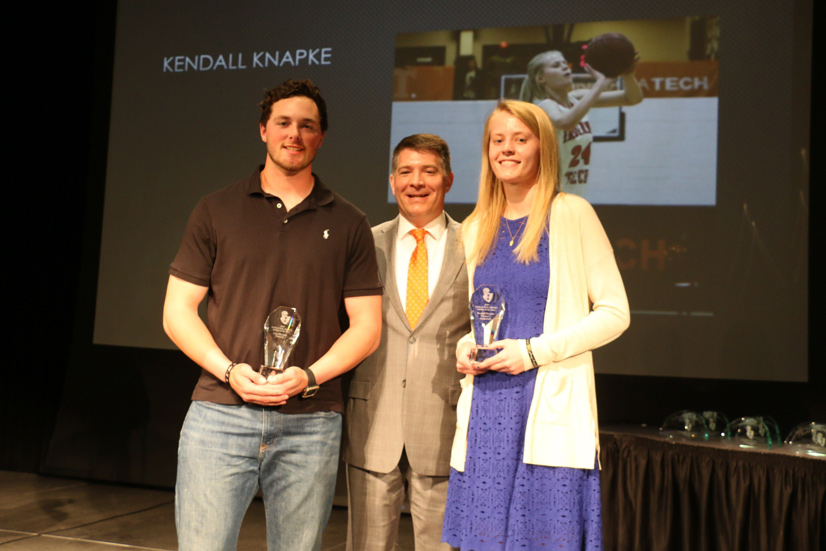 Glen McClain, left, and Kendall Knapke, right, stand with vice president for student affairs Dr. Dan Stoker after being named Indiana Tech’s Athletes of the Year for 2018-19