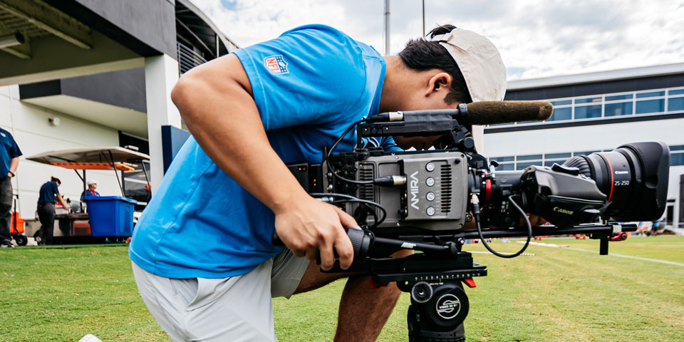 Israel Vaides operating a camera on the field