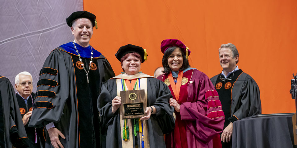 Staci Lugar-Brettin receiving faculty of the year award