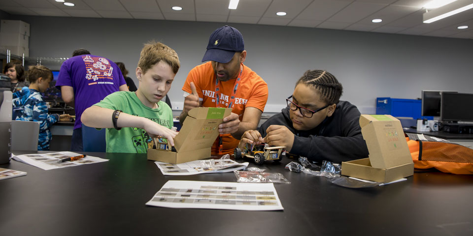 Campers building a car